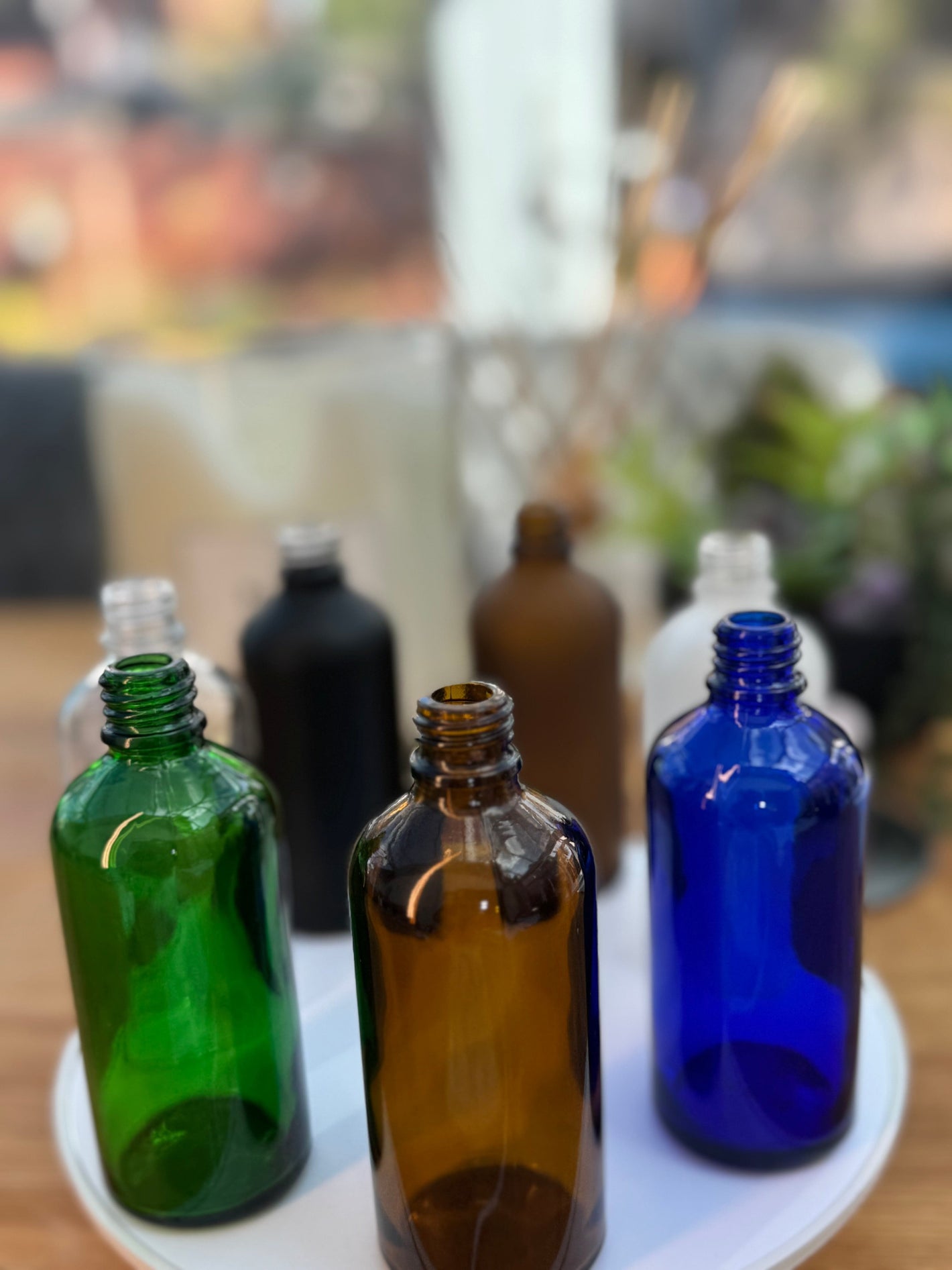 100ml Glass Dropper bottles in a group showing Amber glass bottle, Green Glass Bottle, Blue Glass Bottle, Clear Glass Bottle, Matte Black glass Bottle, Frosted Amber Glass bottle, Frosted White  Glass Bottle