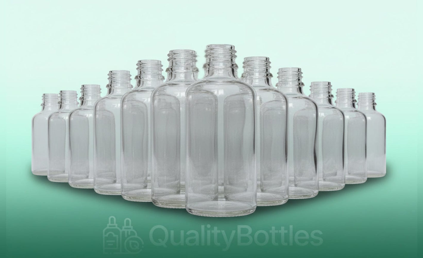 A collection of empty 30ml clear glass dropper bottles arranged in a pyramid shape against a light green background.
