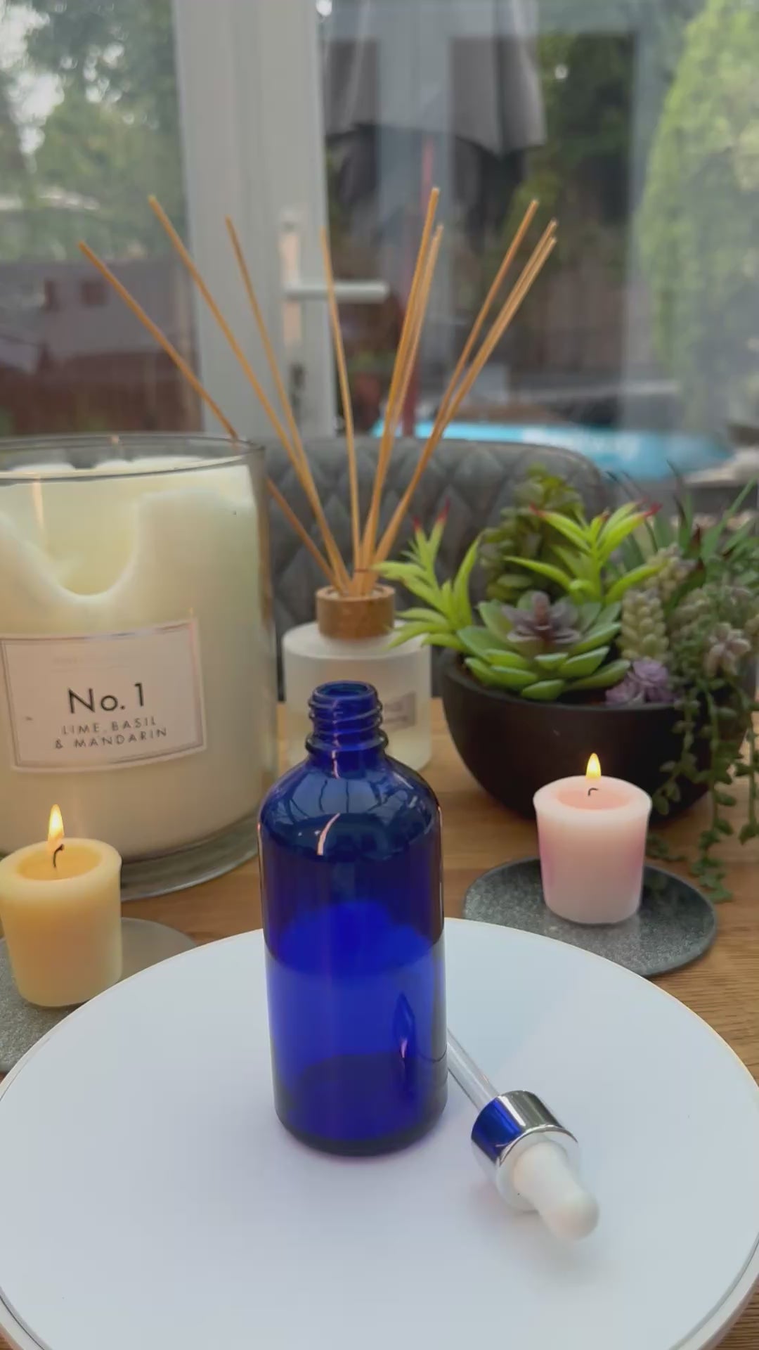100ml Blue glass dropper bottle with silver and white bulb dropper assembly. carousel